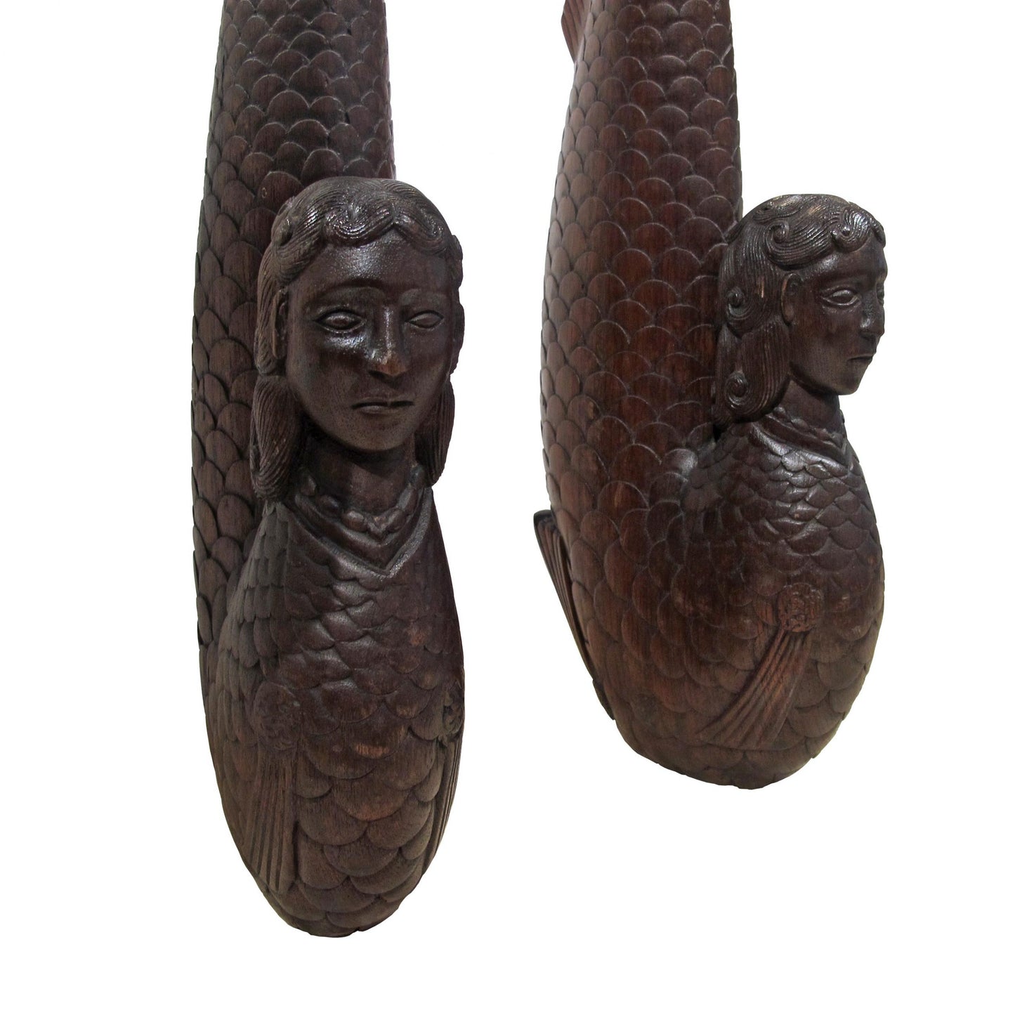 A pair of carved wood mermaids