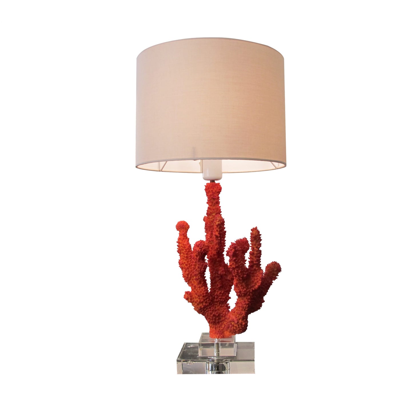 A pair of resin red coral table lamps on a glass base, mid century