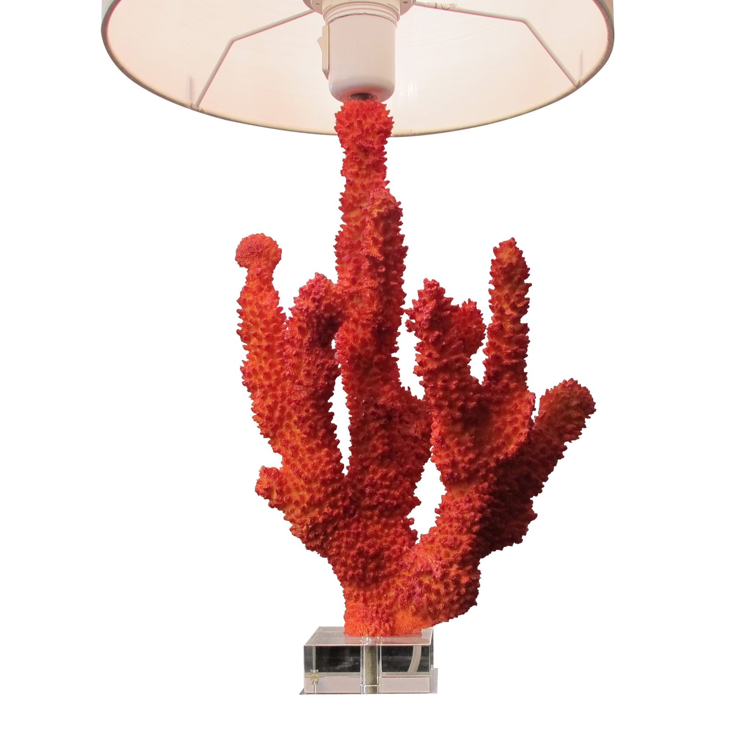 A pair of resin red coral table lamps on a glass base, mid century