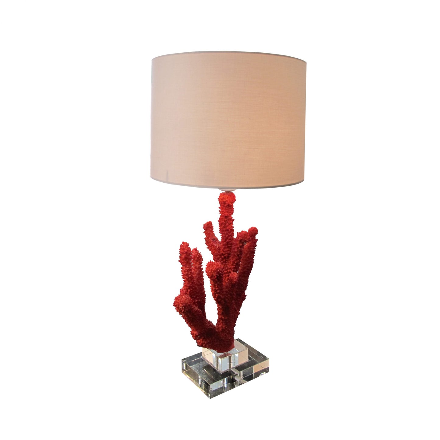 A pair of resin red coral table lamps on a glass base, mid century