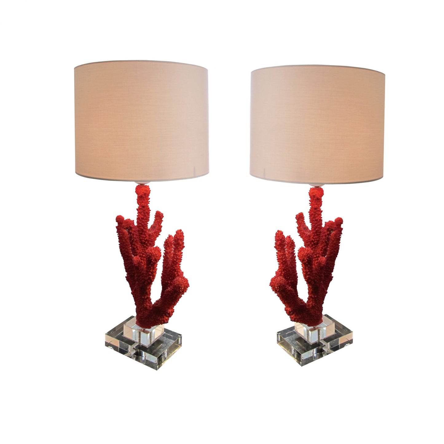 A pair of resin red coral table lamps on a glass base, mid century