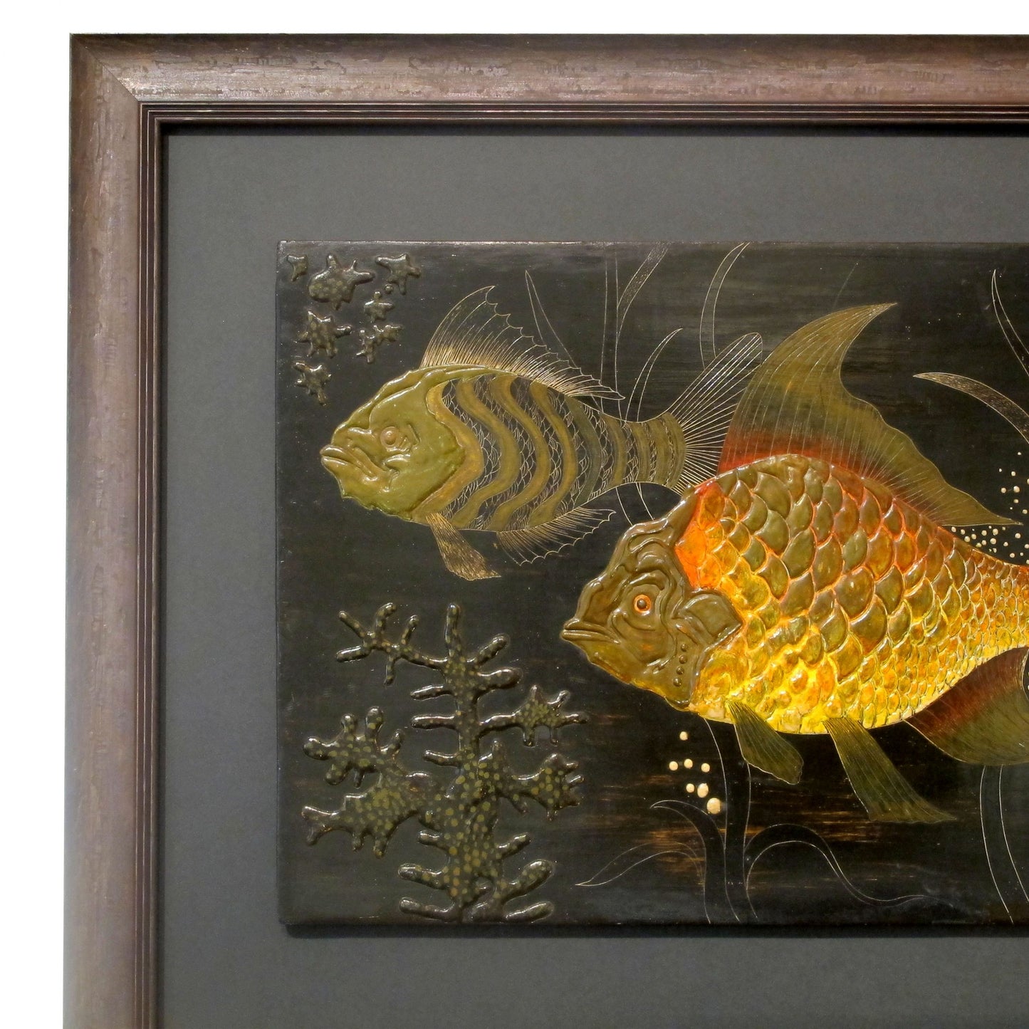 A painted wall plaster relief of fish underwater by H. De Penanros